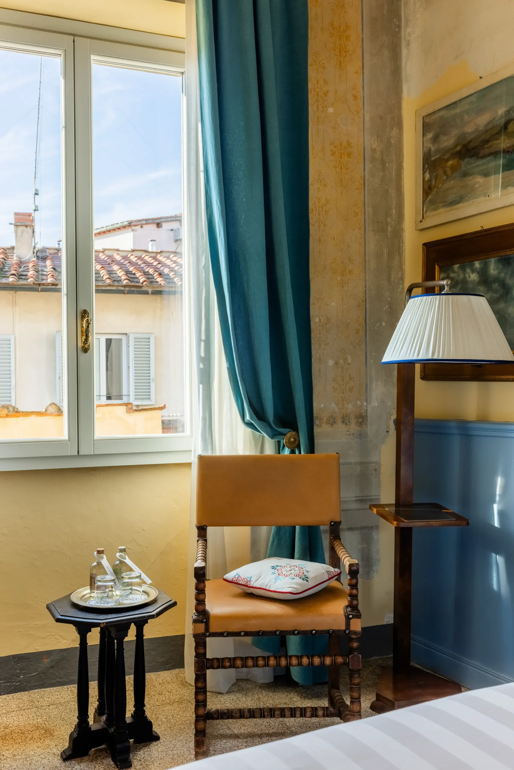 Historic boutique hotel interior at Stella d’Italia Florence with Renaissance architecture, elegant Italian design, warm textures, and atmospheric light.