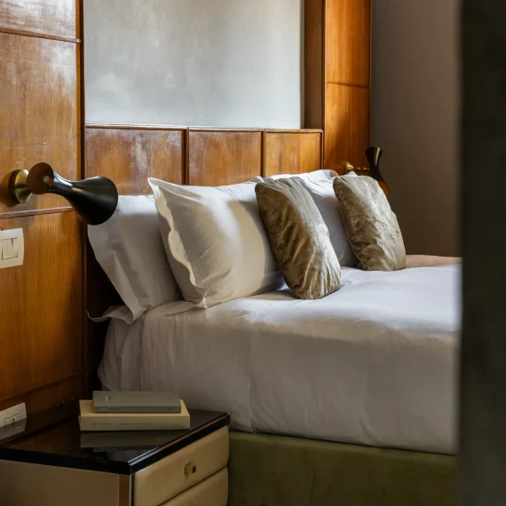 Boutique hotel interior at Oltrarno Splendid Florence featuring eclectic vintage design, layered textures, natural light, and elegant Italian atmosphere.