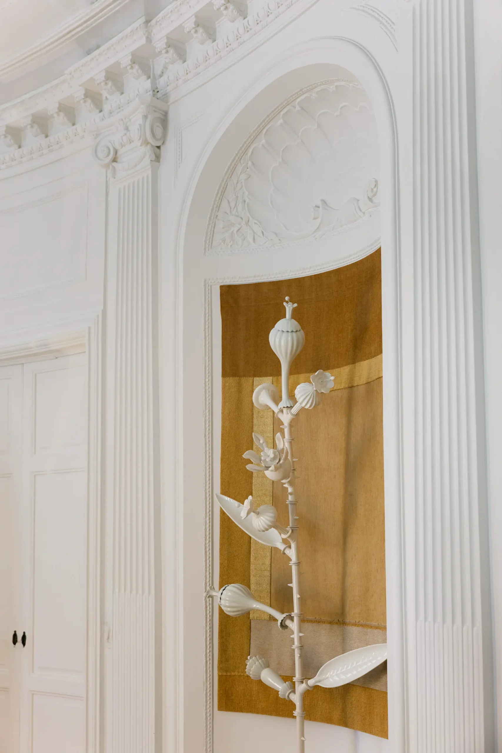 Contemporary interior installation by Artemest in Milan featuring collectible Italian design, sculptural furniture, layered textures, warm tones, and atmospheric natural light.