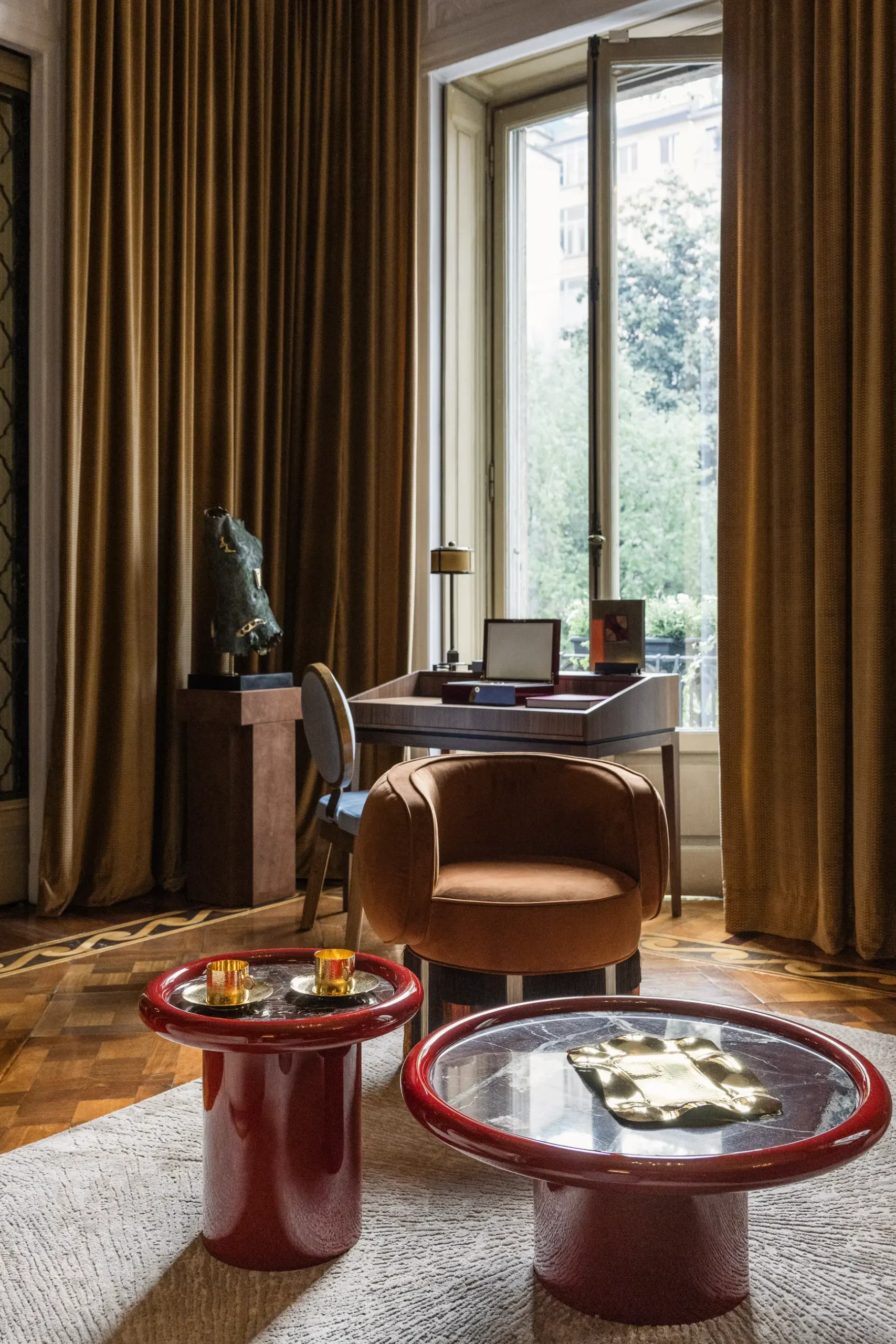 Contemporary interior installation by Artemest in Milan featuring collectible Italian design, sculptural furniture, layered textures, warm tones, and atmospheric natural light.