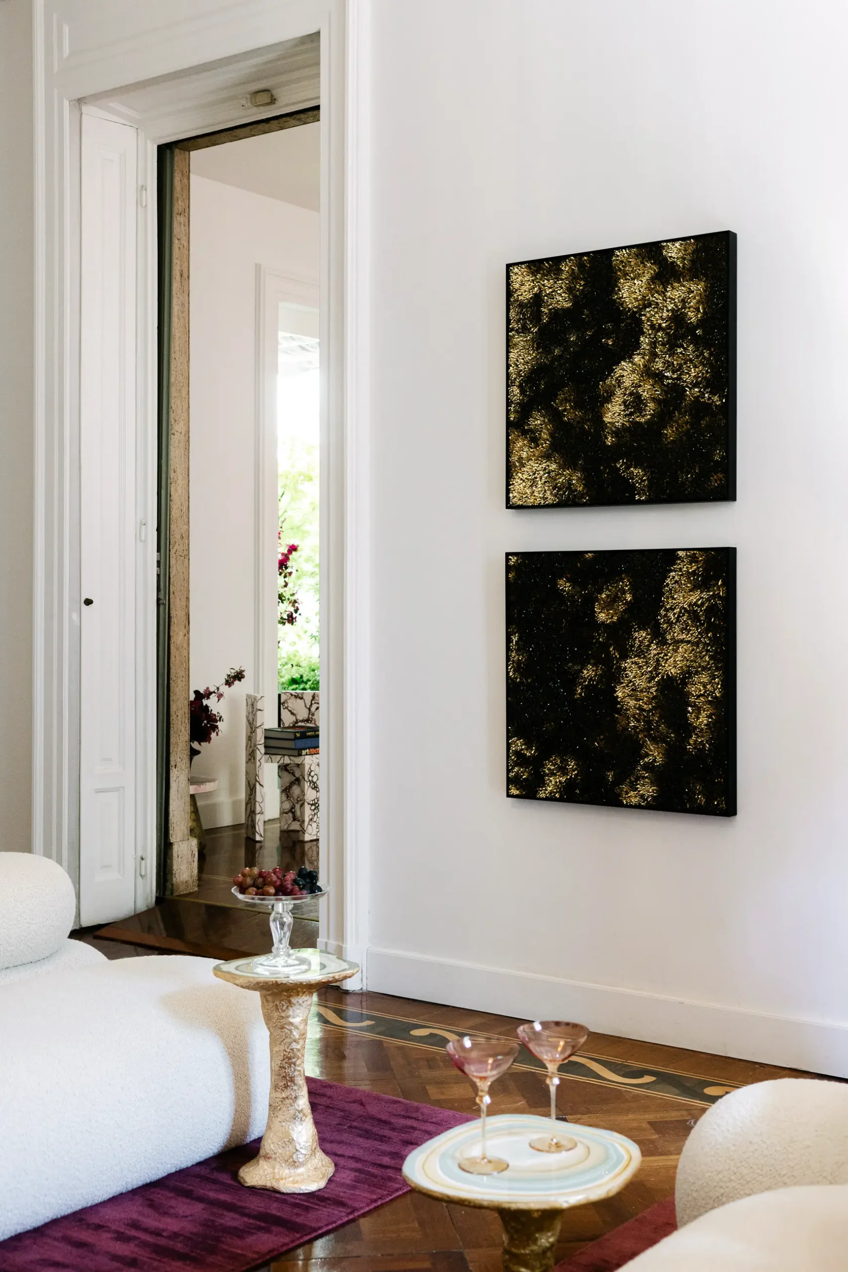 Contemporary interior installation by Artemest in Milan featuring collectible Italian design, sculptural furniture, layered textures, warm tones, and atmospheric natural light.