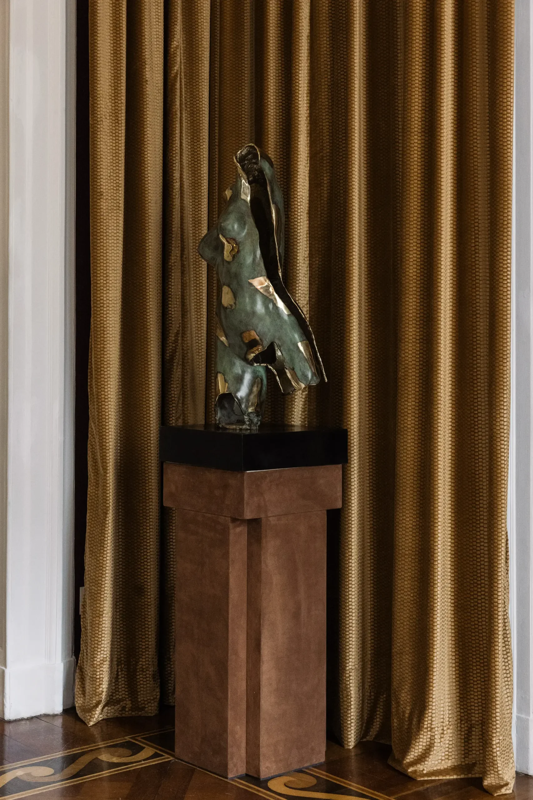 Contemporary interior installation by Artemest in Milan featuring collectible Italian design, sculptural furniture, layered textures, warm tones, and atmospheric natural light.