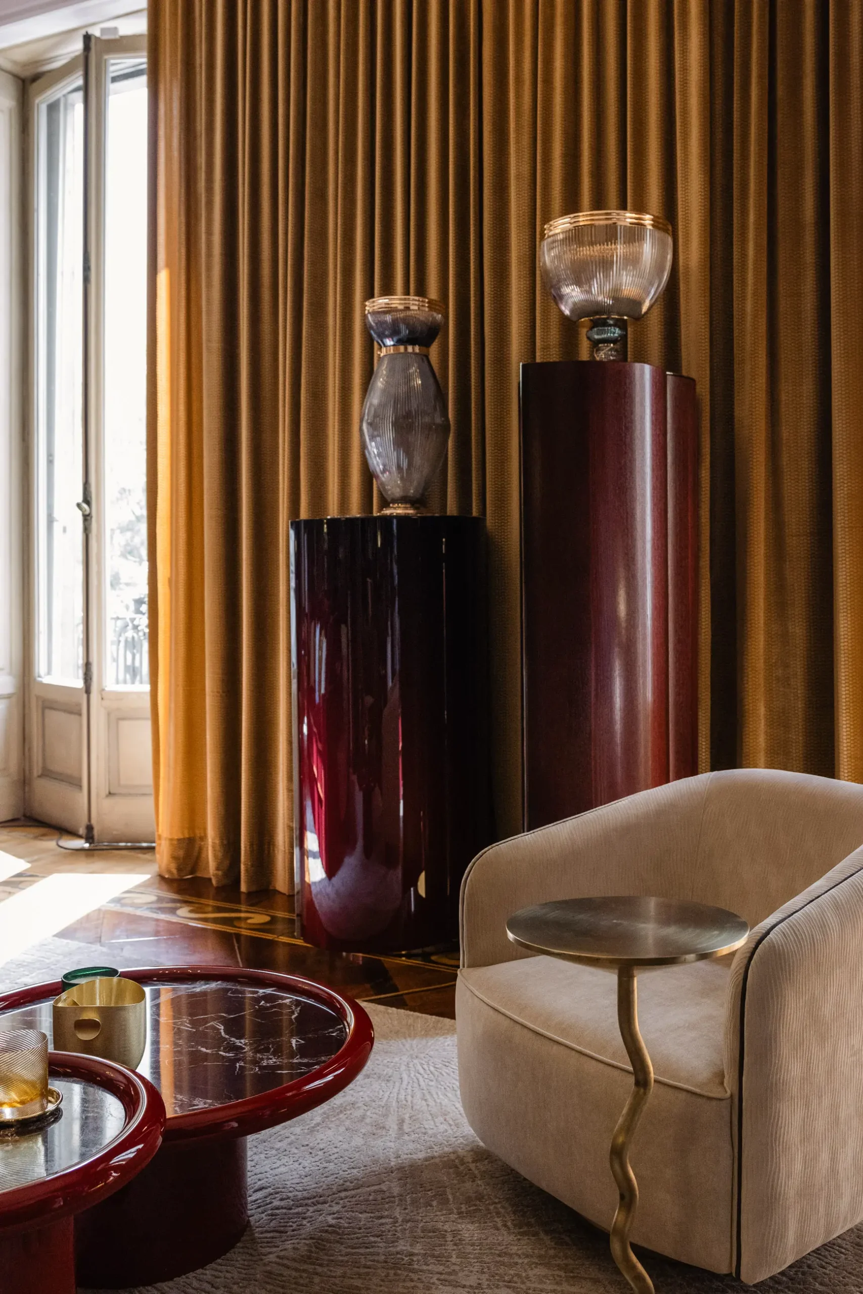 Contemporary interior installation by Artemest in Milan featuring collectible Italian design, sculptural furniture, layered textures, warm tones, and atmospheric natural light.