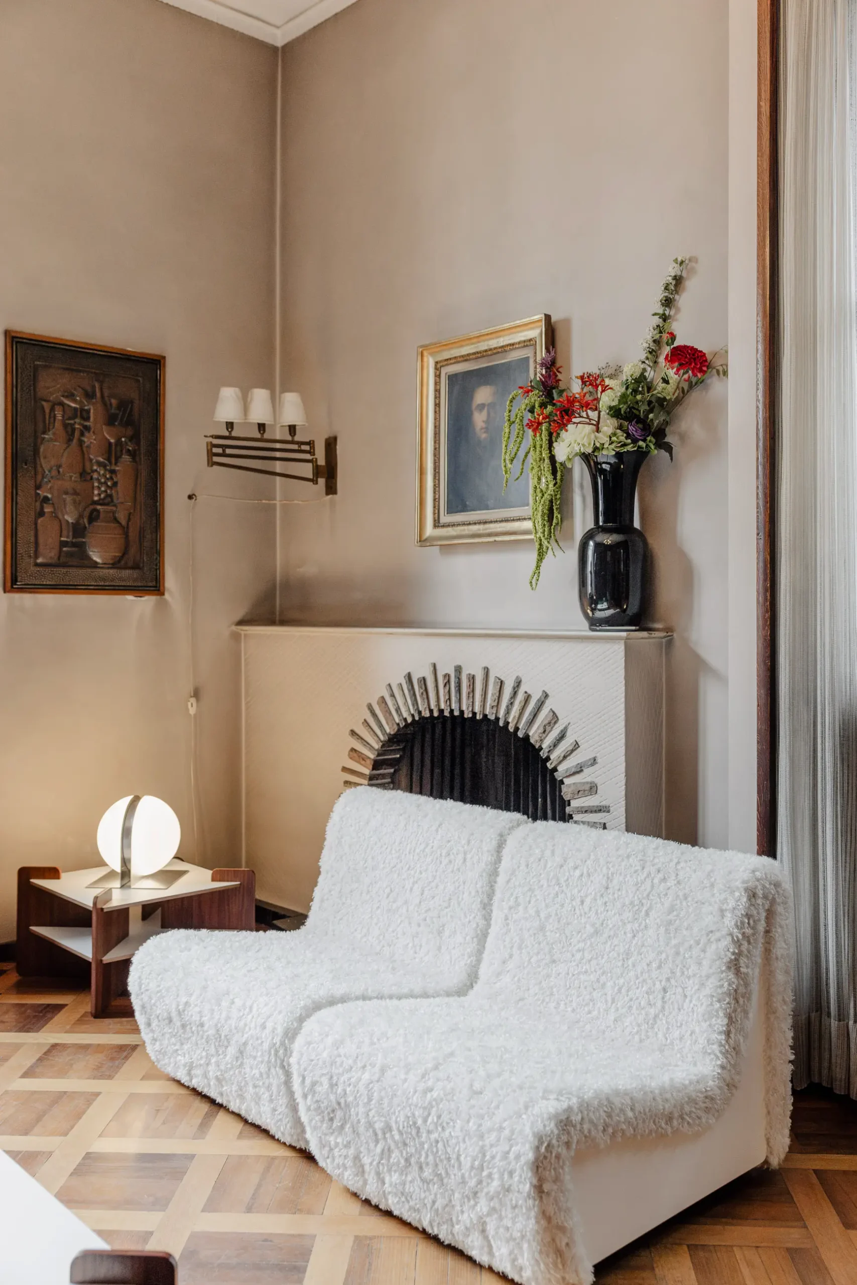 Atmospheric contemporary design installation at Alcova Milan with experimental interiors, sculptural objects, raw textures, and dramatic architectural light.