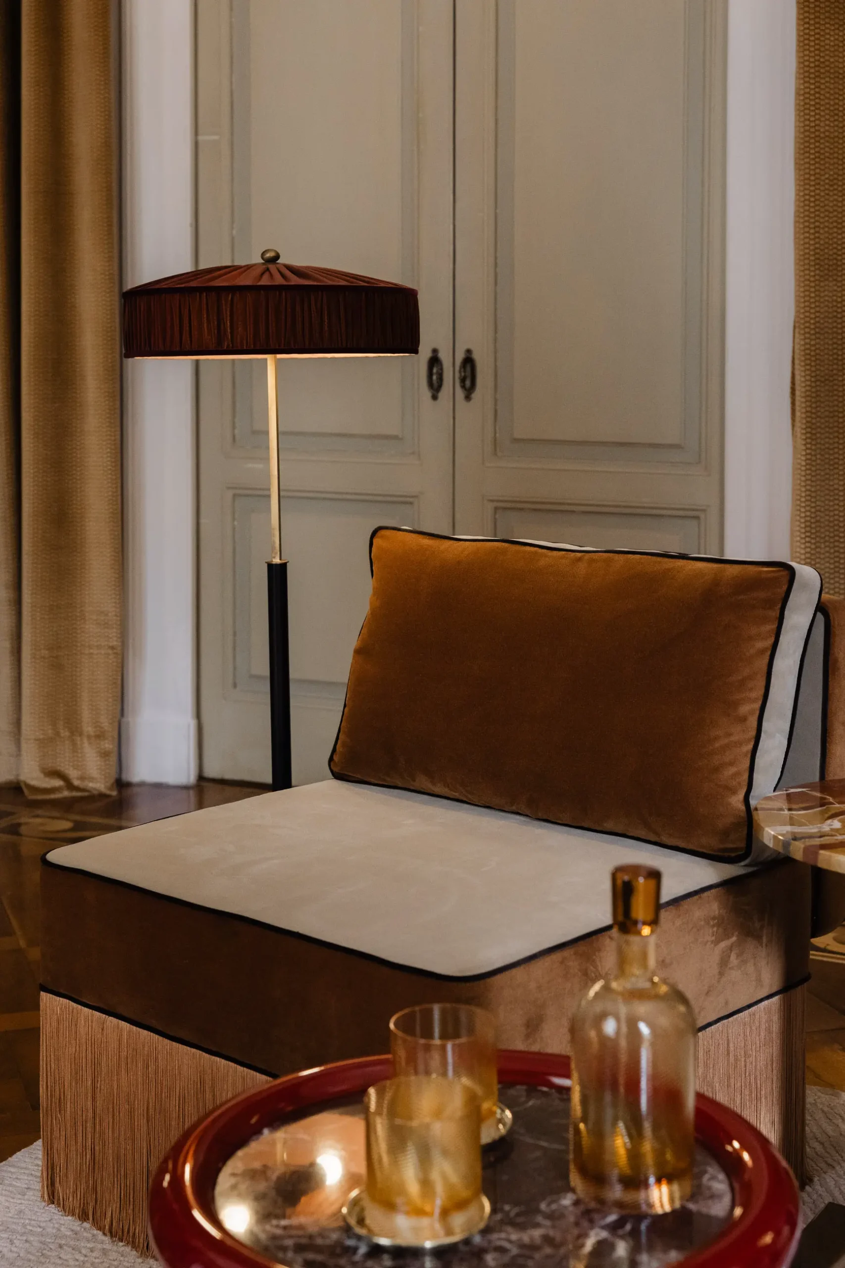 Contemporary interior installation by Artemest in Milan featuring collectible Italian design, sculptural furniture, layered textures, warm tones, and atmospheric natural light.