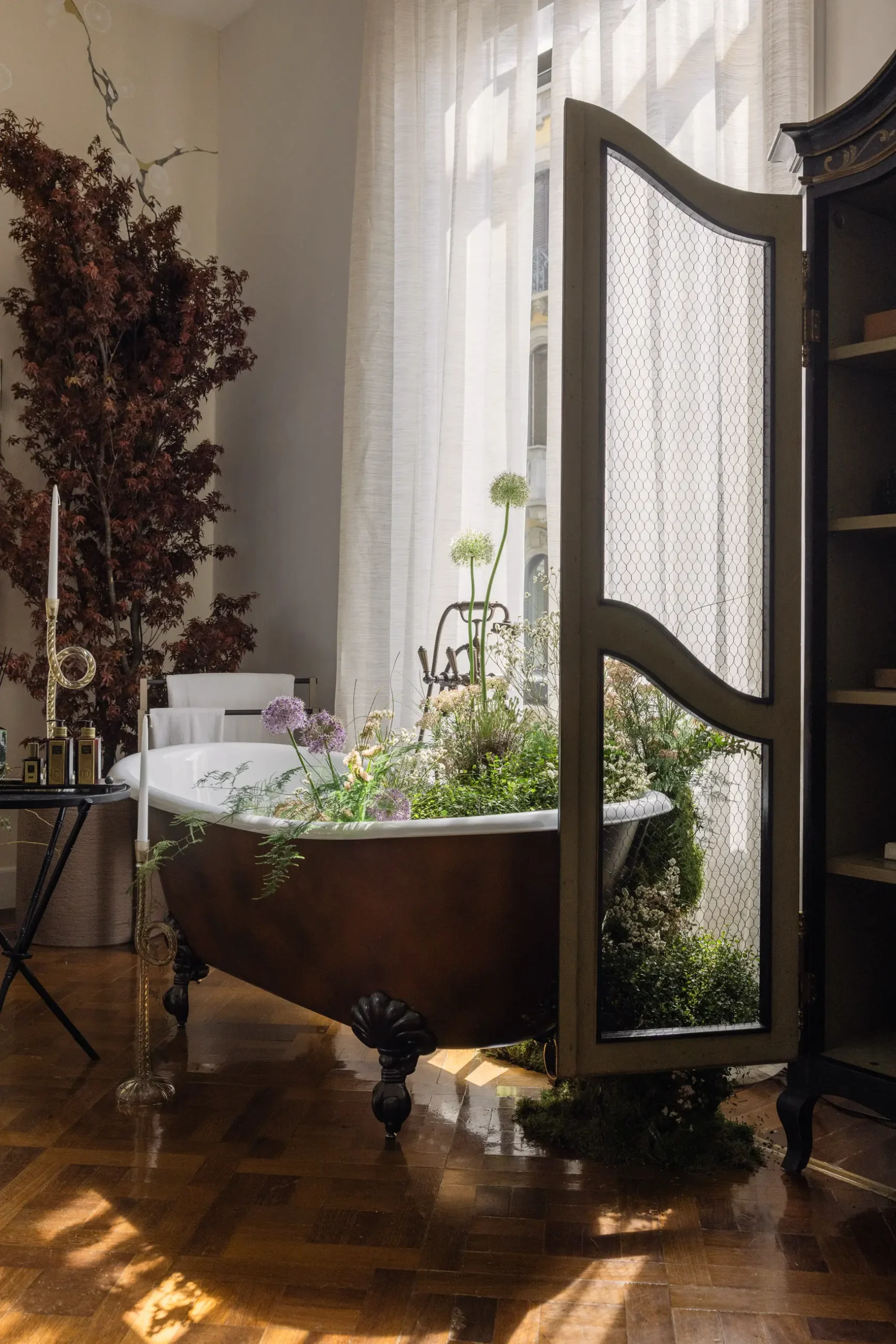 Contemporary interior installation by Artemest in Milan featuring collectible Italian design, sculptural furniture, layered textures, warm tones, and atmospheric natural light.