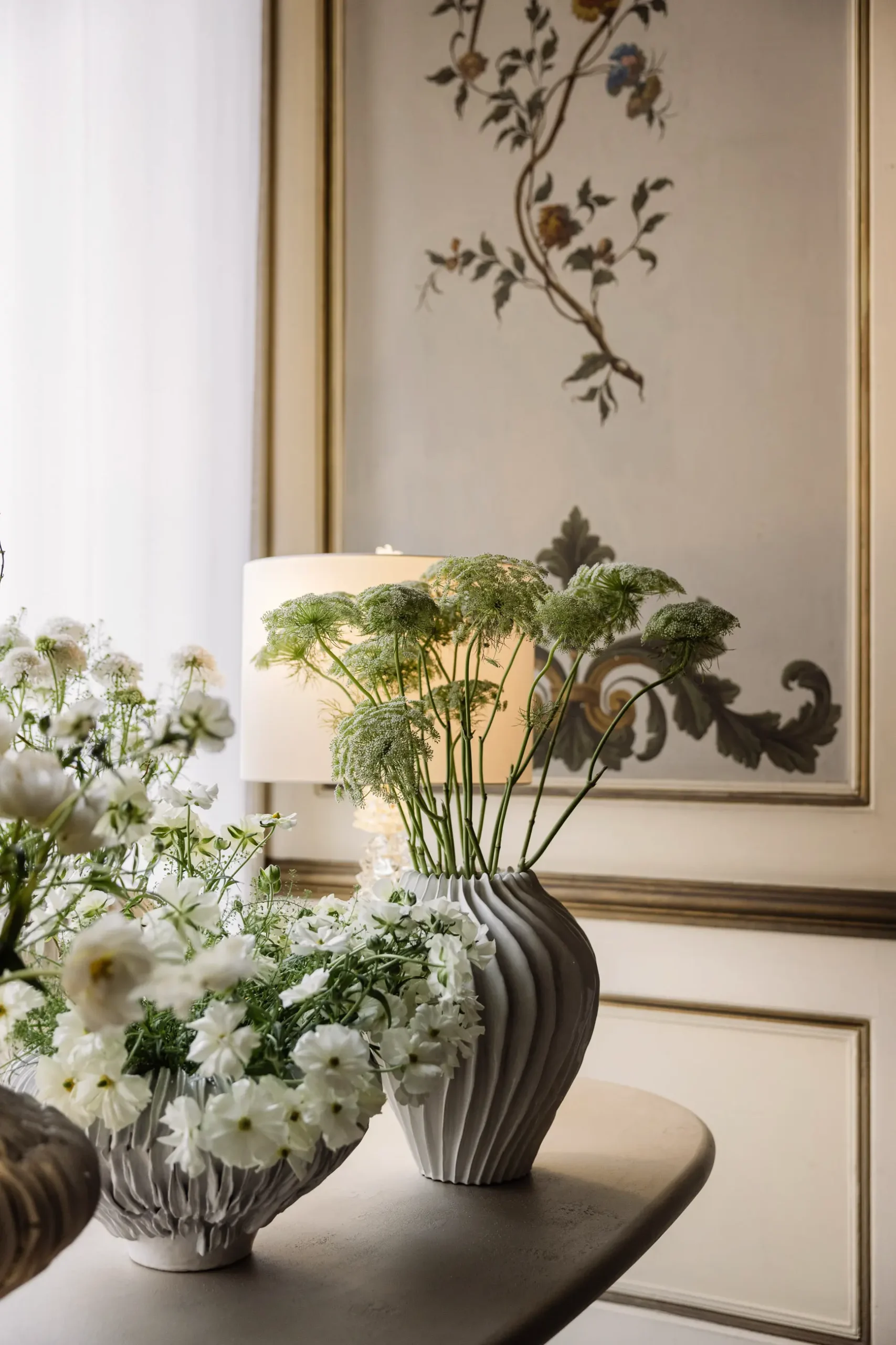 Contemporary interior installation by Artemest in Milan featuring collectible Italian design, sculptural furniture, layered textures, warm tones, and atmospheric natural light.