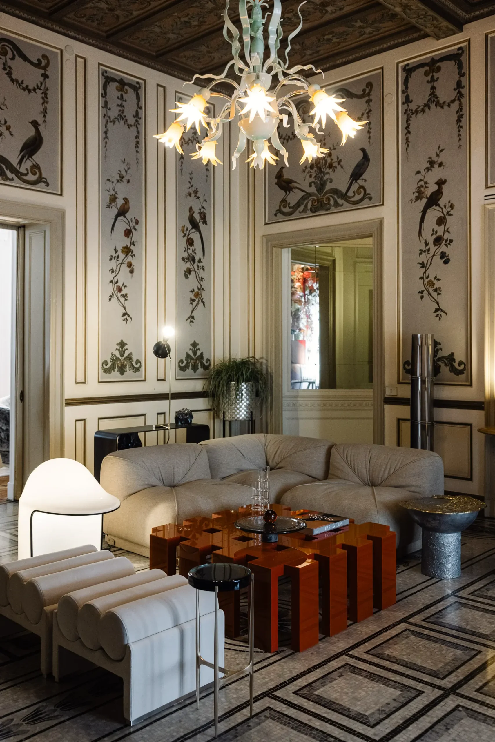 Contemporary interior installation by Artemest in Milan featuring collectible Italian design, sculptural furniture, layered textures, warm tones, and atmospheric natural light.