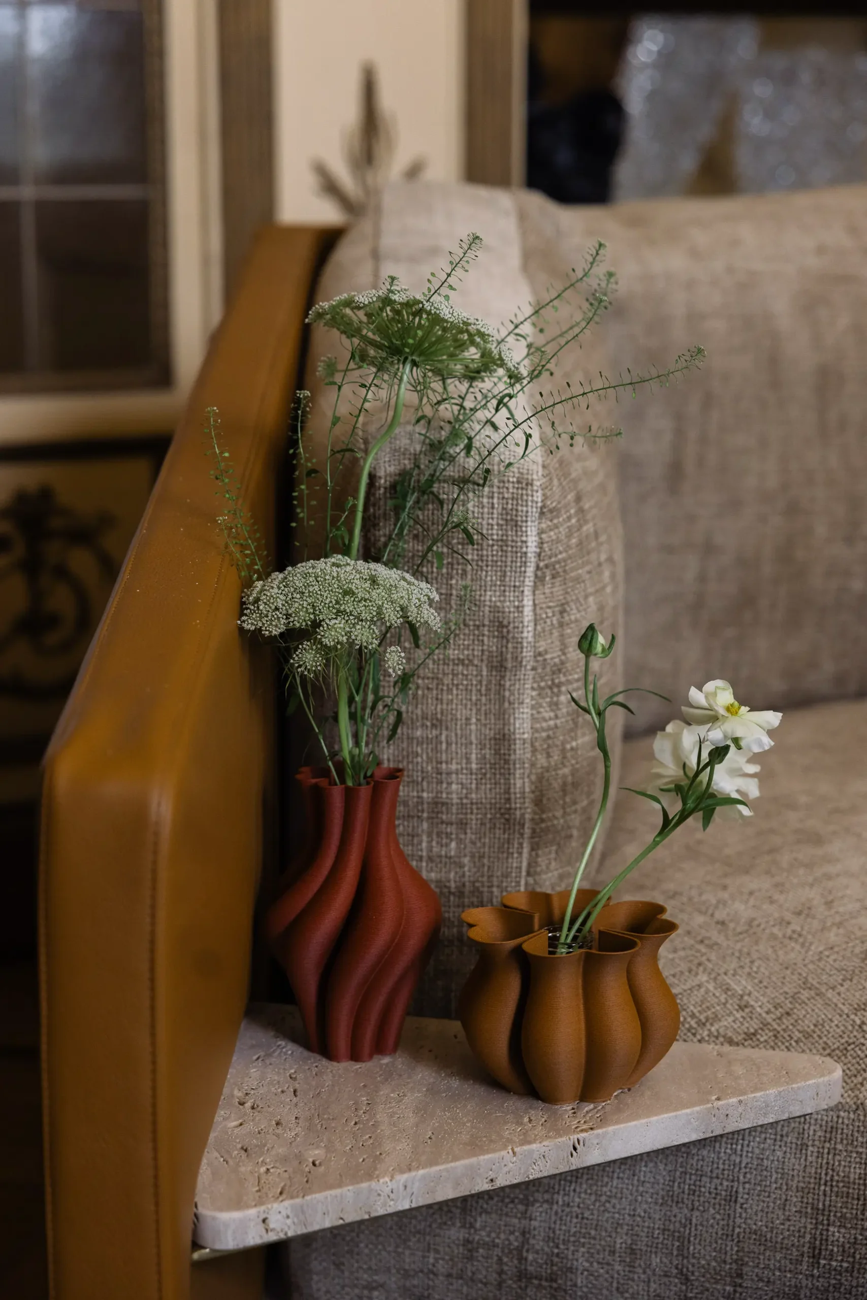 Contemporary interior installation by Artemest in Milan featuring collectible Italian design, sculptural furniture, layered textures, warm tones, and atmospheric natural light.