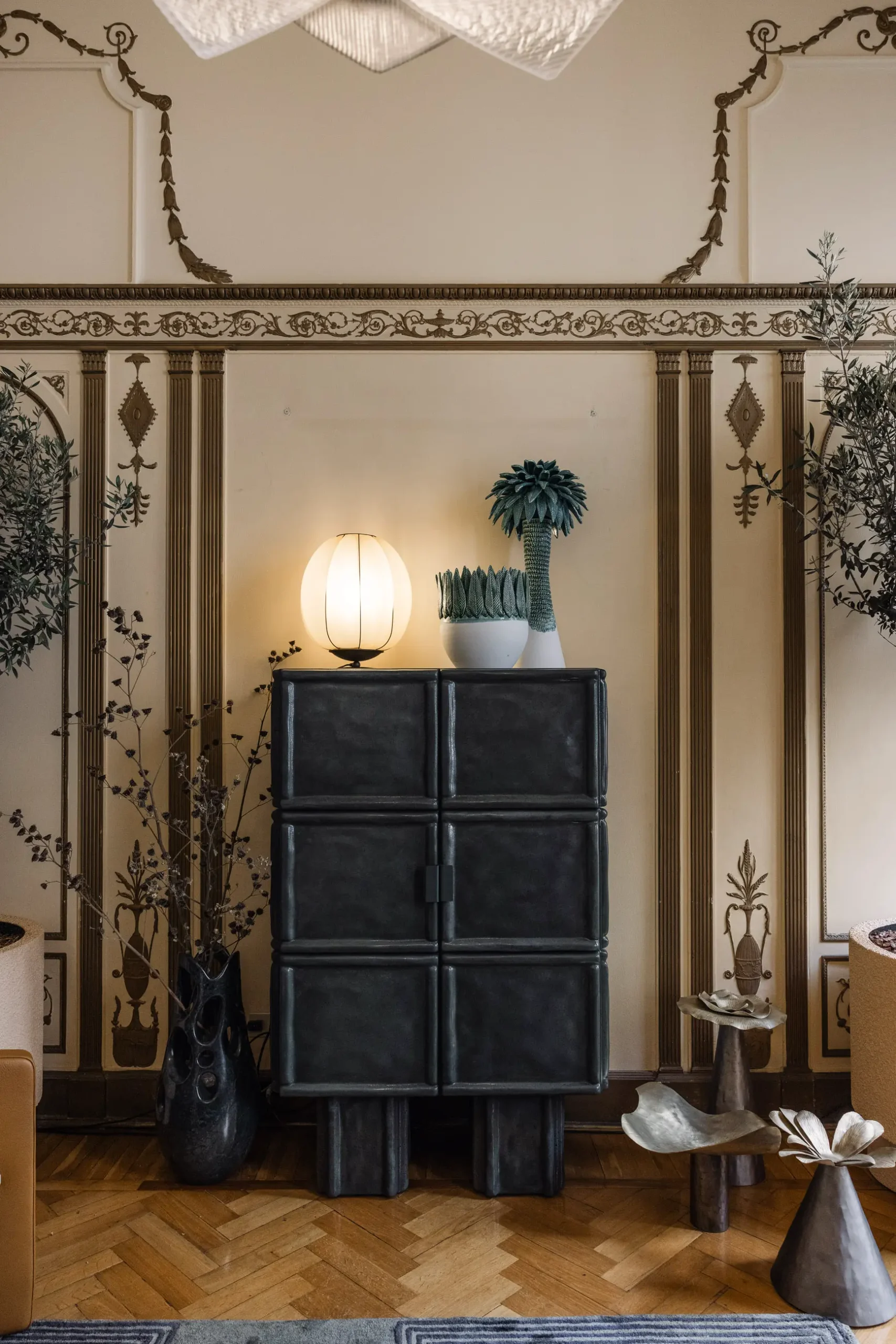 Contemporary interior installation by Artemest in Milan featuring collectible Italian design, sculptural furniture, layered textures, warm tones, and atmospheric natural light.