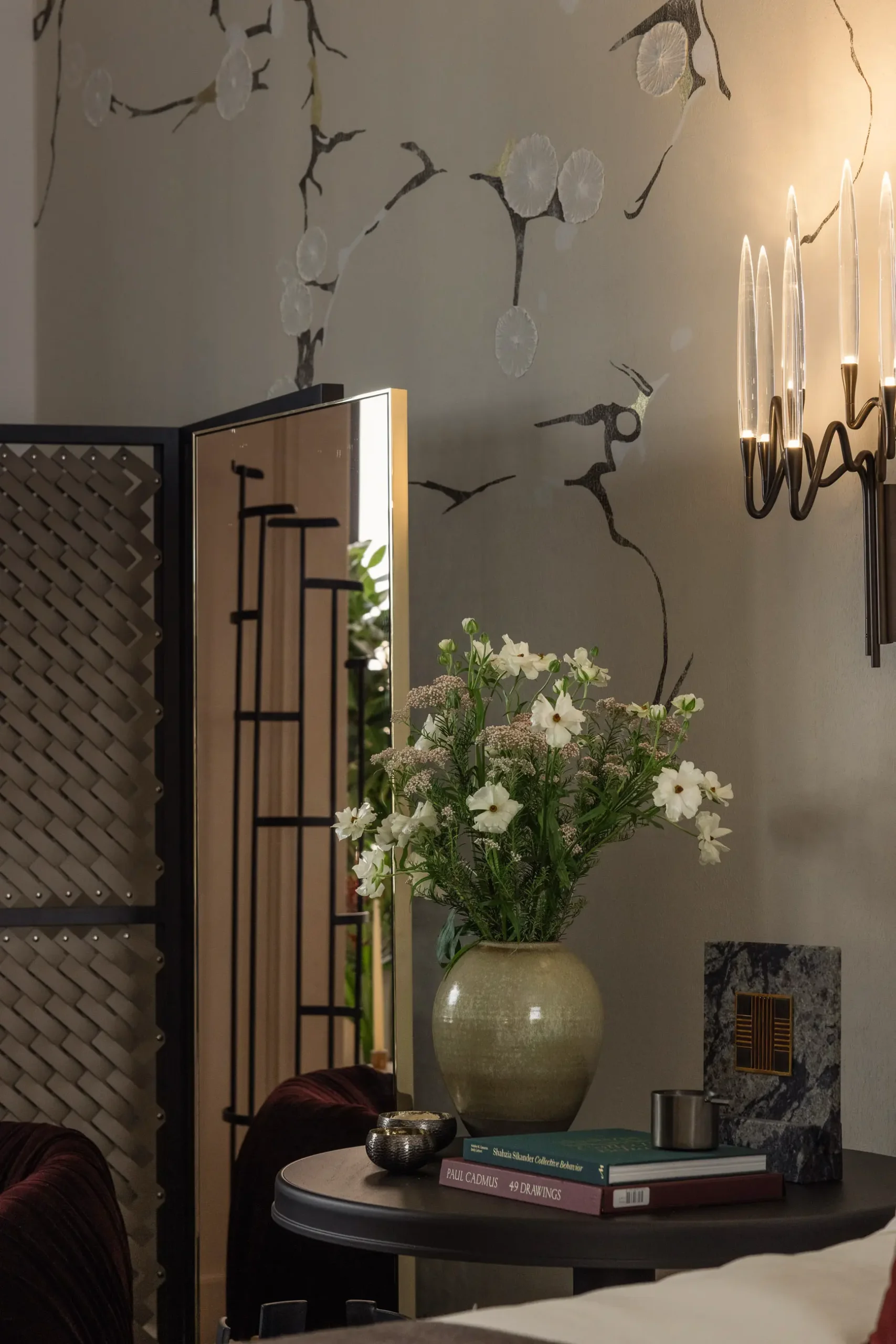 Contemporary interior installation by Artemest in Milan featuring collectible Italian design, sculptural furniture, layered textures, warm tones, and atmospheric natural light.