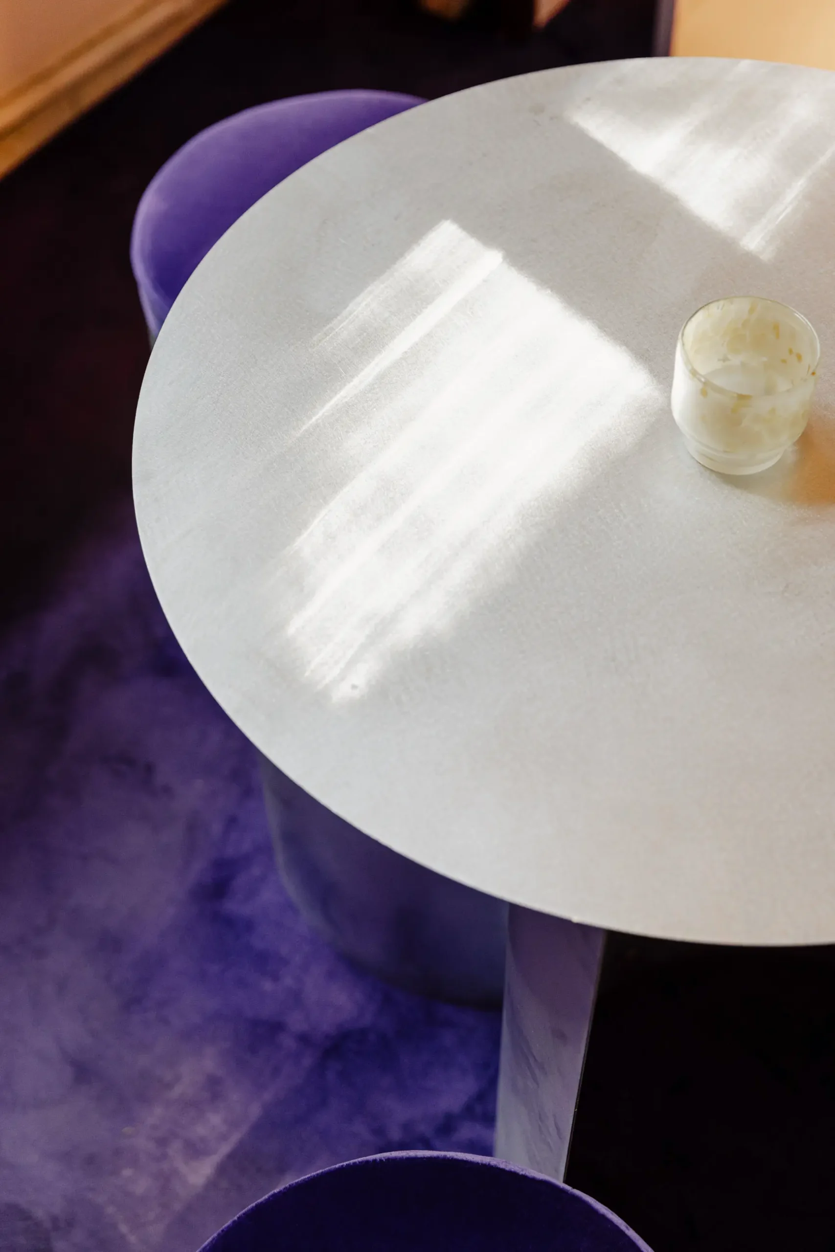 Atmospheric contemporary design installation at Alcova Milan with experimental interiors, sculptural objects, raw textures, and dramatic architectural light.